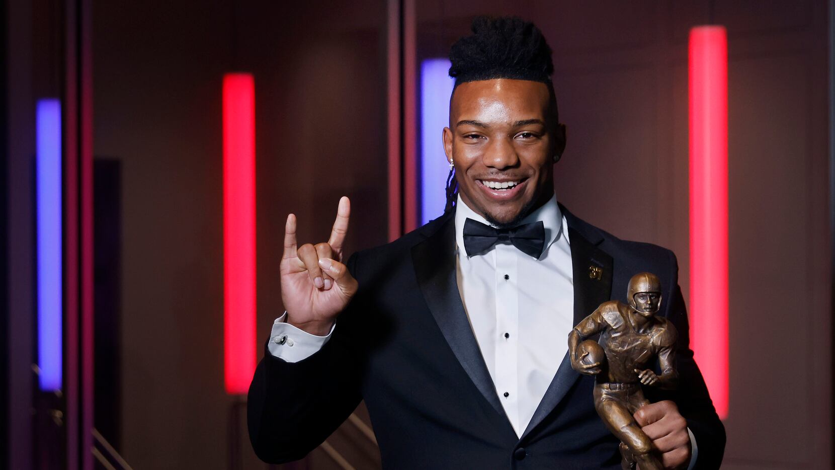 Doak Walker Award recipient Bijan Robinson of the University of Texas pose with the trophy...