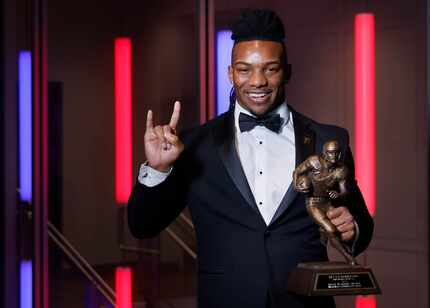 Doak Walker Award recipient Bijan Robinson of the University of Texas pose with the trophy...