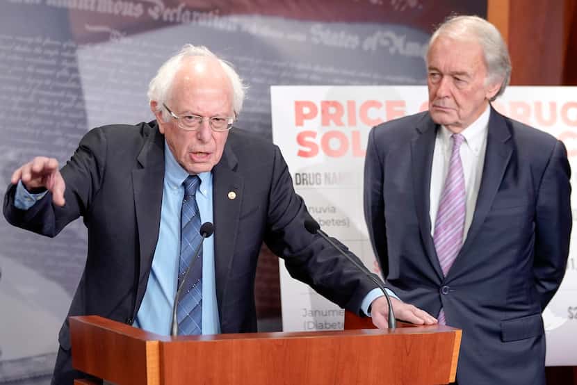 FILE - Sen. Bernie Sanders, I-Vt., left, speaks during a news conference on Senate Health,...
