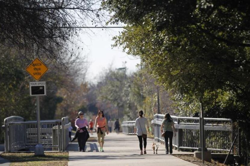 
People enjoy walking the Katy Trail close to the Katy Trail Ice House. 
