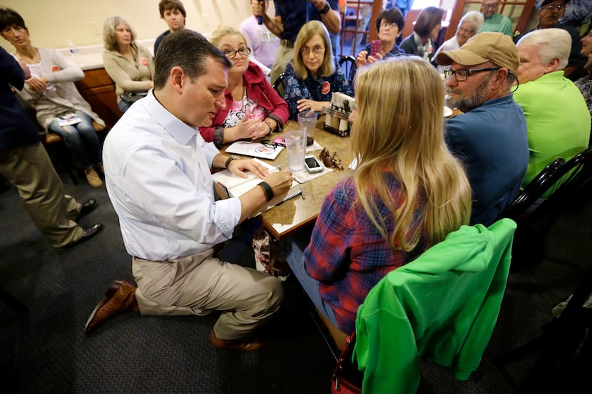Republican presidential candidate, Sen. Ted Cruz, R-Texas, signs an autograph during a...