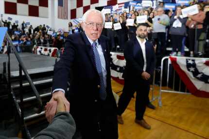 Sen. Bernie Sanders shakes hands with a supporter after a campaign rally in Dearborn, Mich.,...