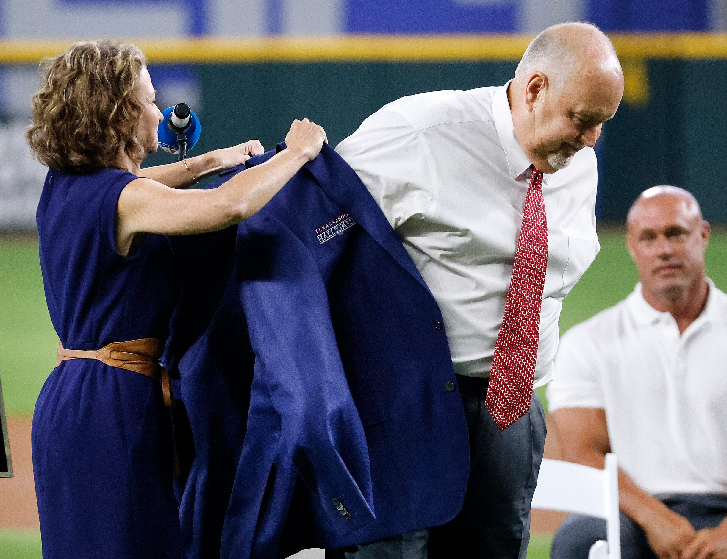 Texas Rangers executive vice president and public address announcer Chuck Morgan receives...