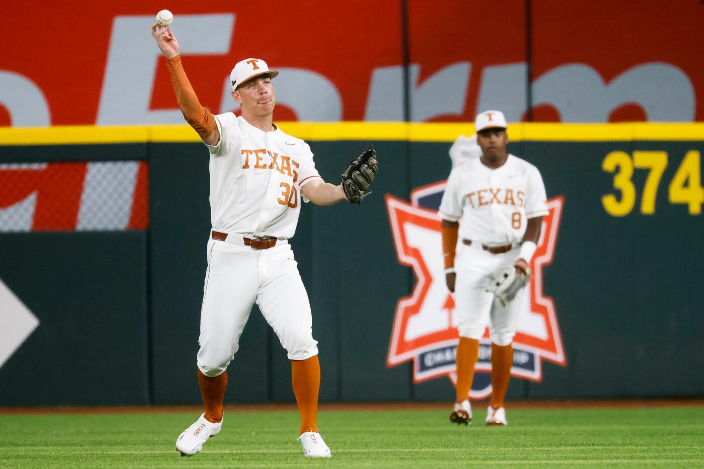 Texas outfielder Eric Kennedy throws the ball during the first inning of a baseball game...