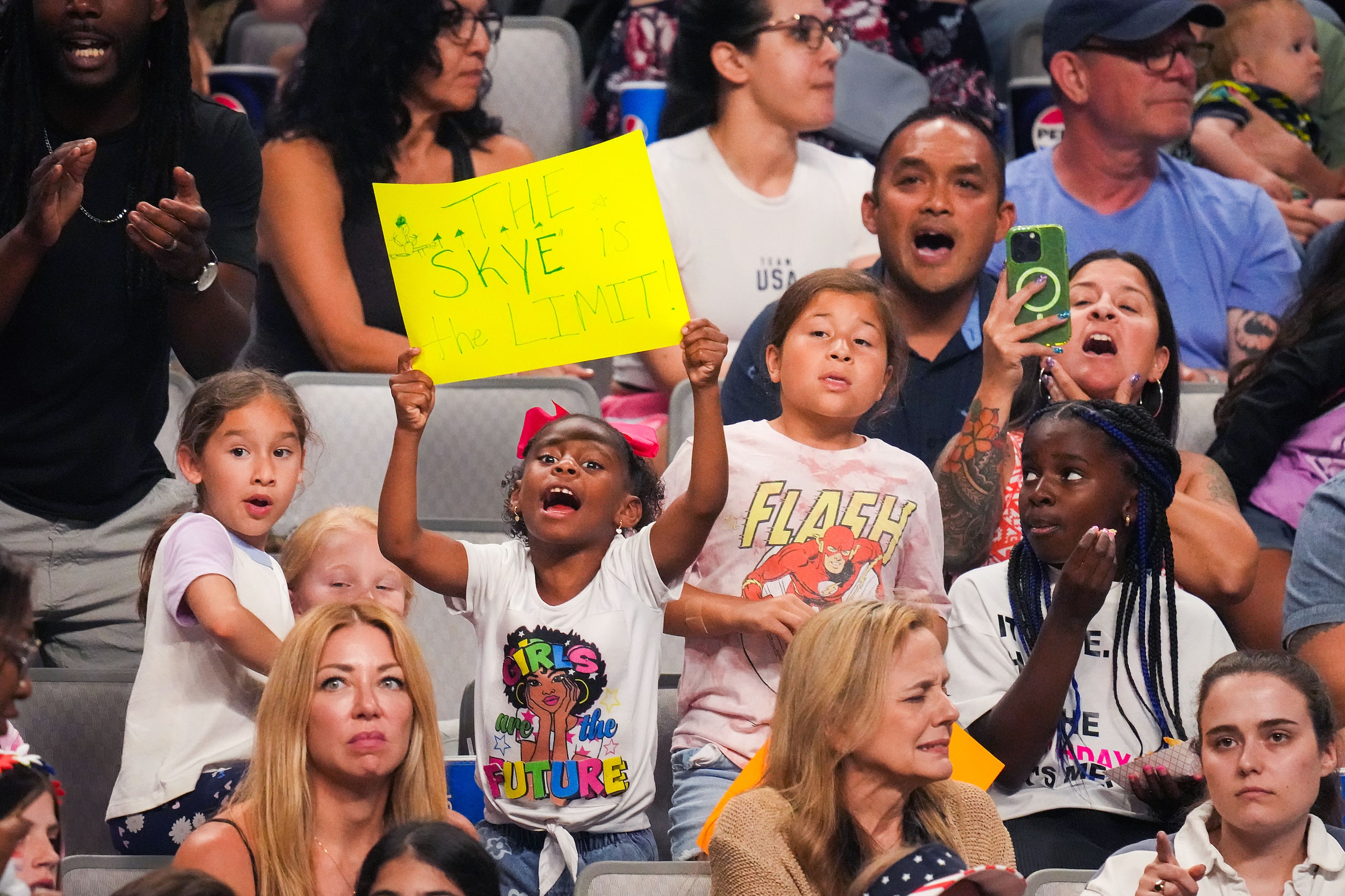 Fans cheer Skye Blakely as she competes on the uneven bars during the U.S. Gymnastics...