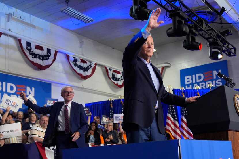 President Joe Biden waves to the crowd as Wisconsin Gov. Tony Evers, left, looks on at a...