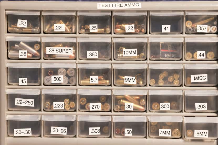 Test ammo in the room where guns found on crime scenes are tested using a machine that...