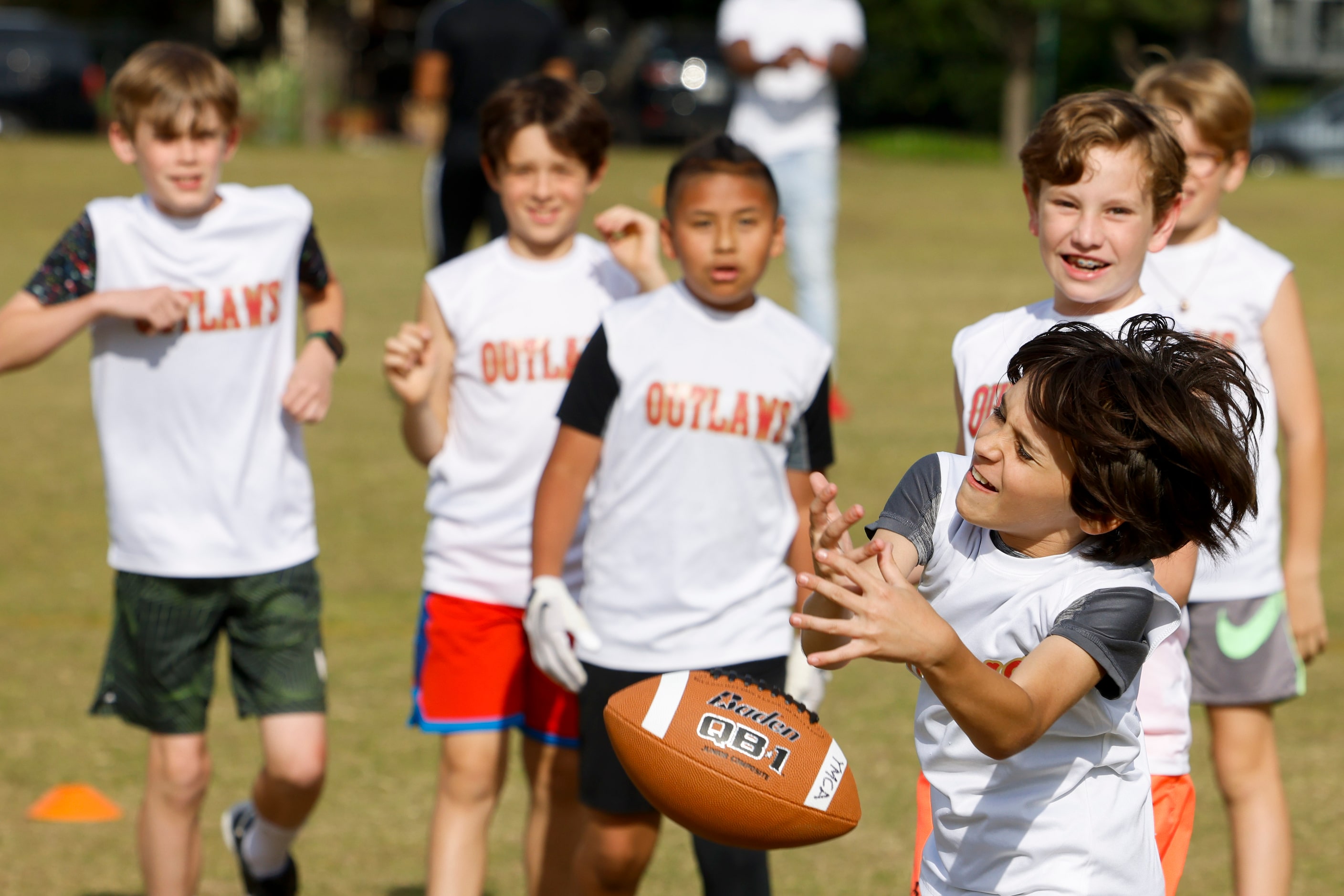 Luke Rudnicki (front) attempts to catch a ball during a special session of football drills...