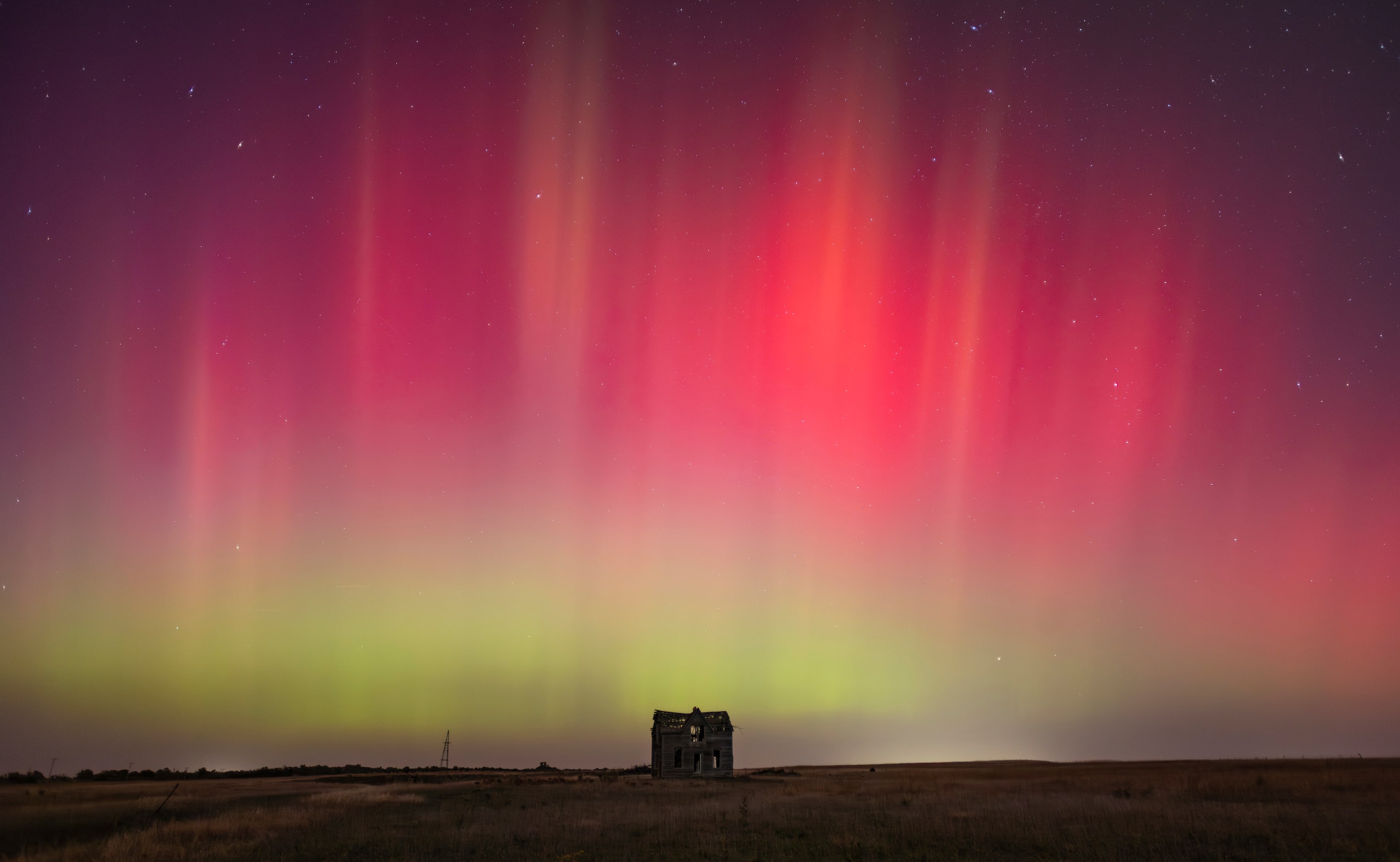 The northern lights are seen over an abandoned farm house near Marquette, Kansas, on...