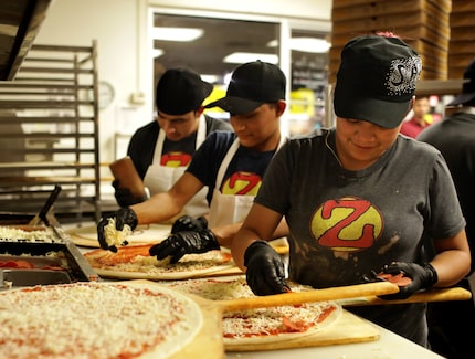 Zalat is known for its crazy-late hours. Pictured here, employees prepare a steady flow of...