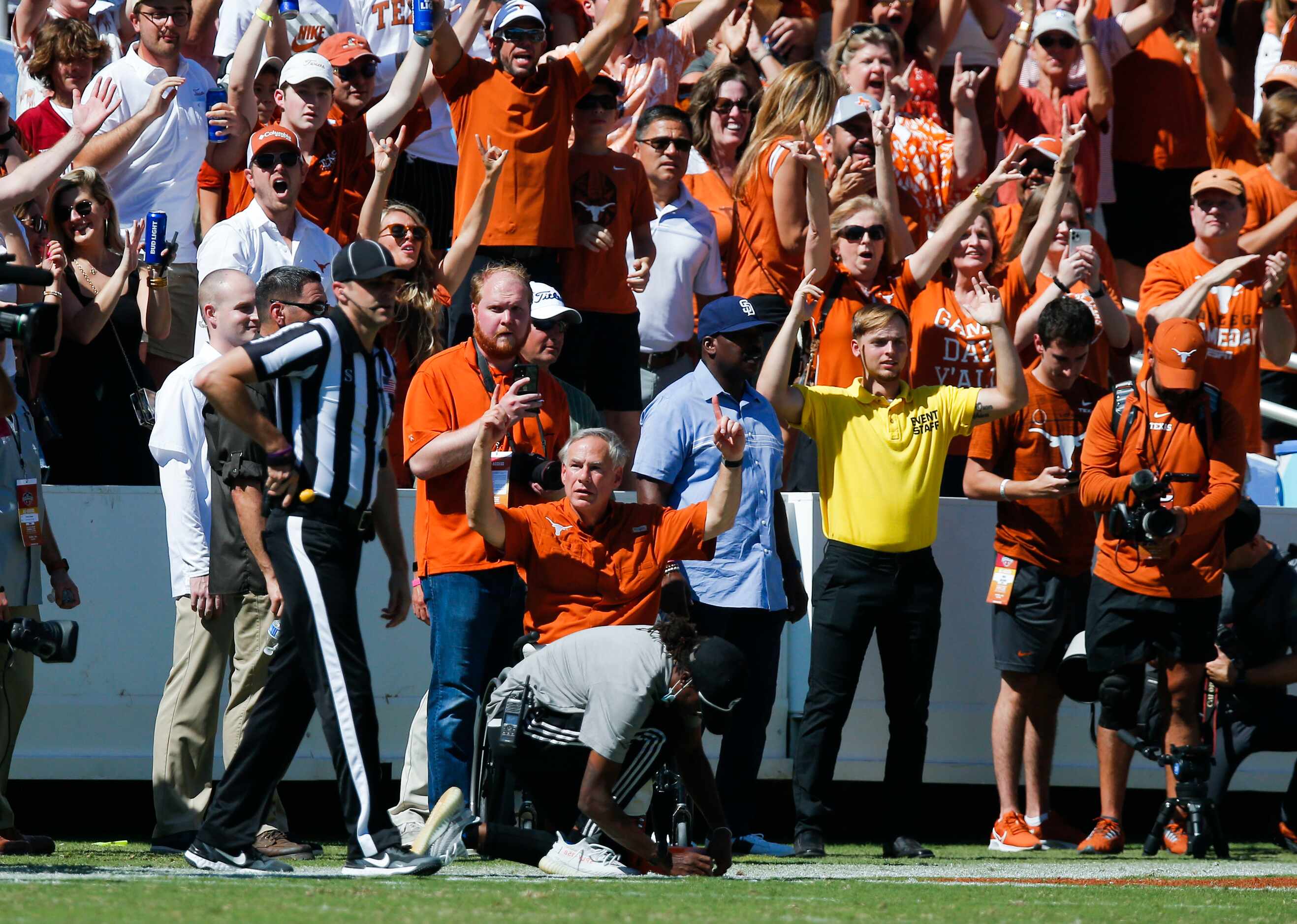 Texas Governor Greg Abbott looks for a touchdown call during the first half of an NCAA...