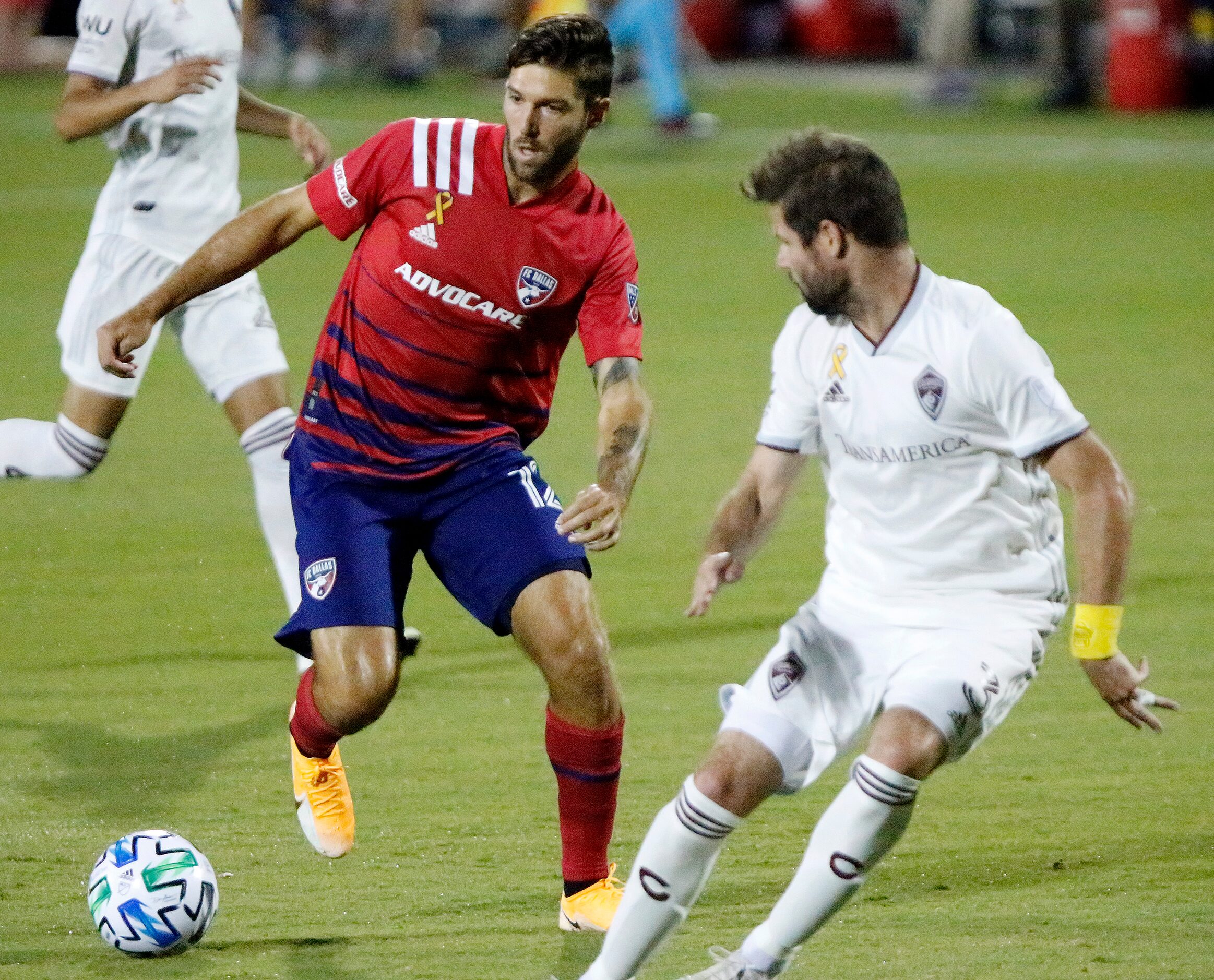 FC Dallas midfielder Ryan Hollingshead (12) dribbles past Colorado Rapids defender Drew Moor...