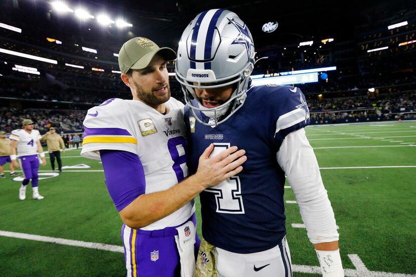 Minnesota Vikings quarterback Kirk Cousins (8) visits with Dallas Cowboys quarterback Dak...