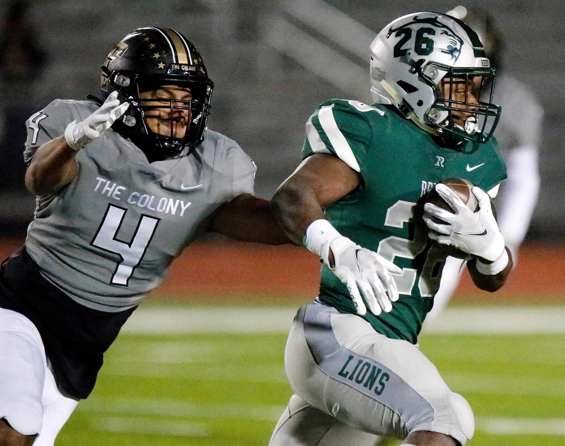 Frisco Reedy High School running back Aaron Daniels (26) escapes the tackle attempt by The...