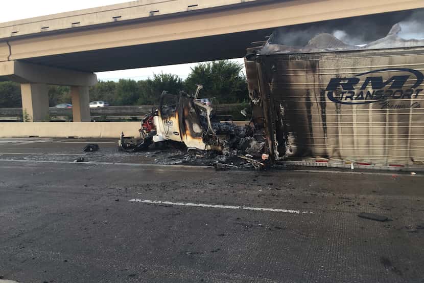 An 18-wheeler caught on fire after hitting the jersey wall on Interstate 35 near the exit to...