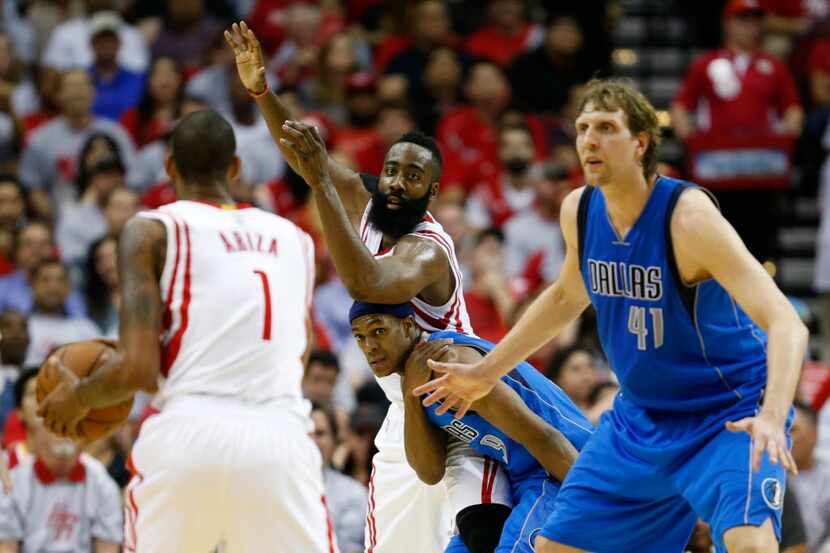 Dallas Mavericks guard Rajon Rondo (9) and Houston Rockets guard James Harden (13) fight for...
