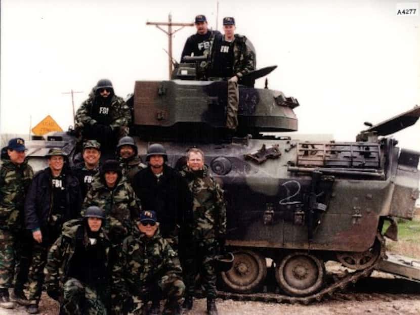 FBI tactical agents pose with one of the tanks used in the Branch Davidian siege near Waco.