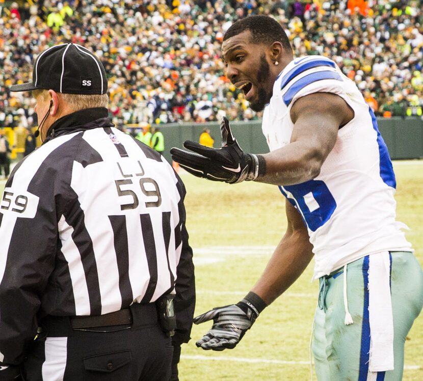 Dallas Cowboys wide receiver Dez Bryant pleads with line judge Rusty Baynes (59) after his...