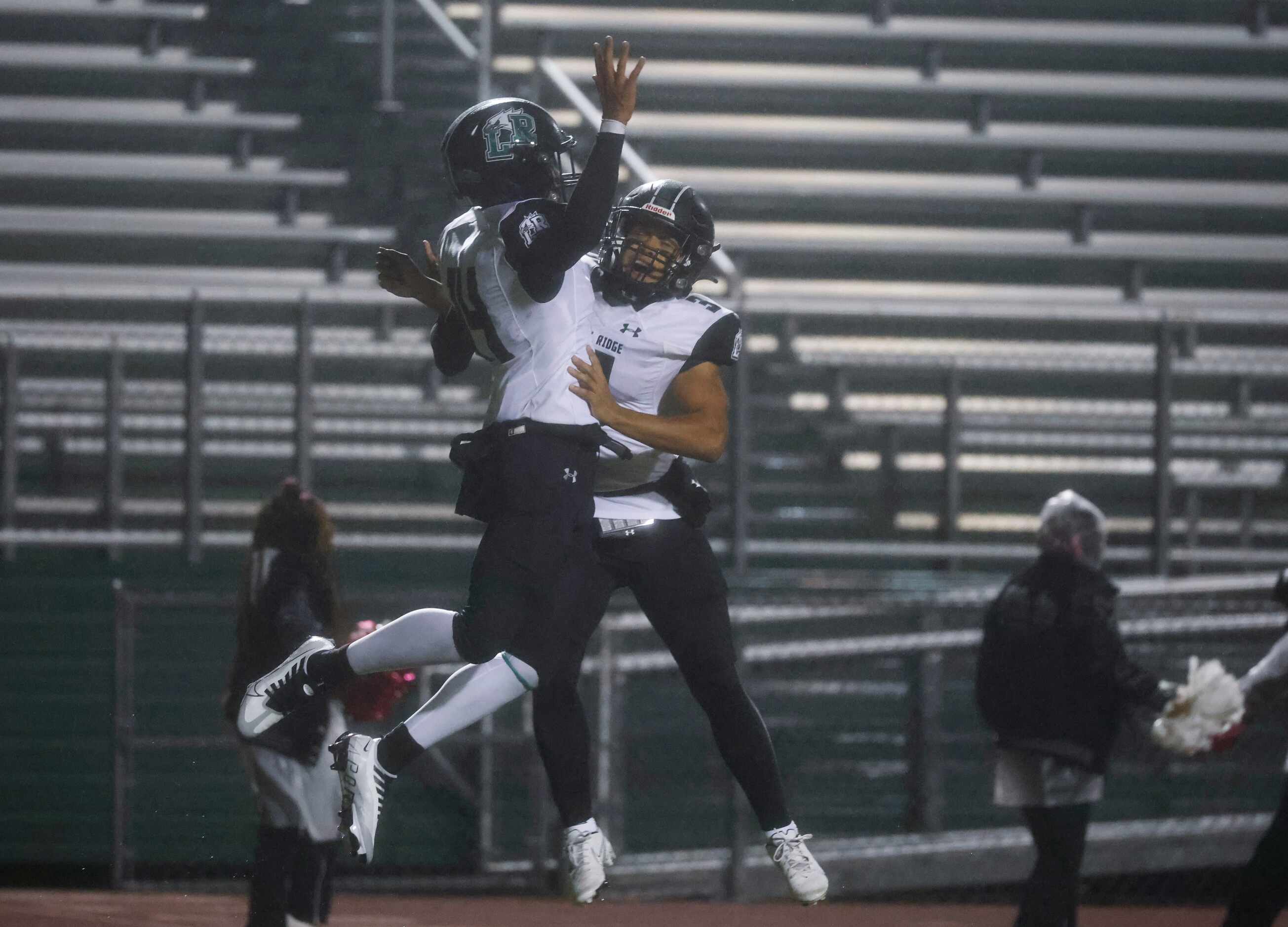 Mansfield Lake Ridge high’s Jamaal Hall (14), left, and Bryce Marcus (3) celebrates...