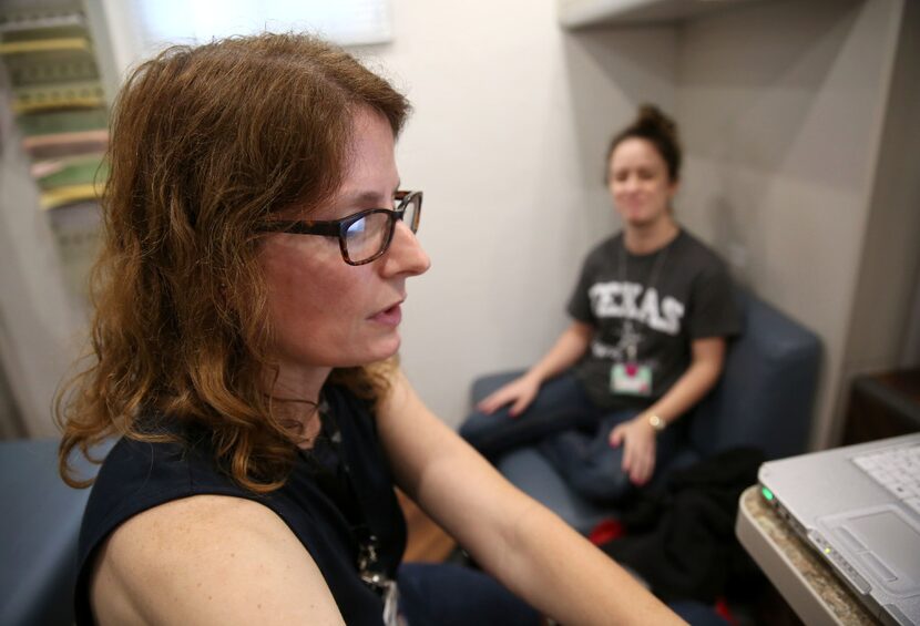 Dr. Lara Johnson, a family medicine physician, talks to patient Monica Frasier inside...