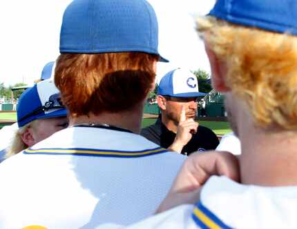 Corsicana head coach Heath Autrey speaks with his players prior to the start of their game...