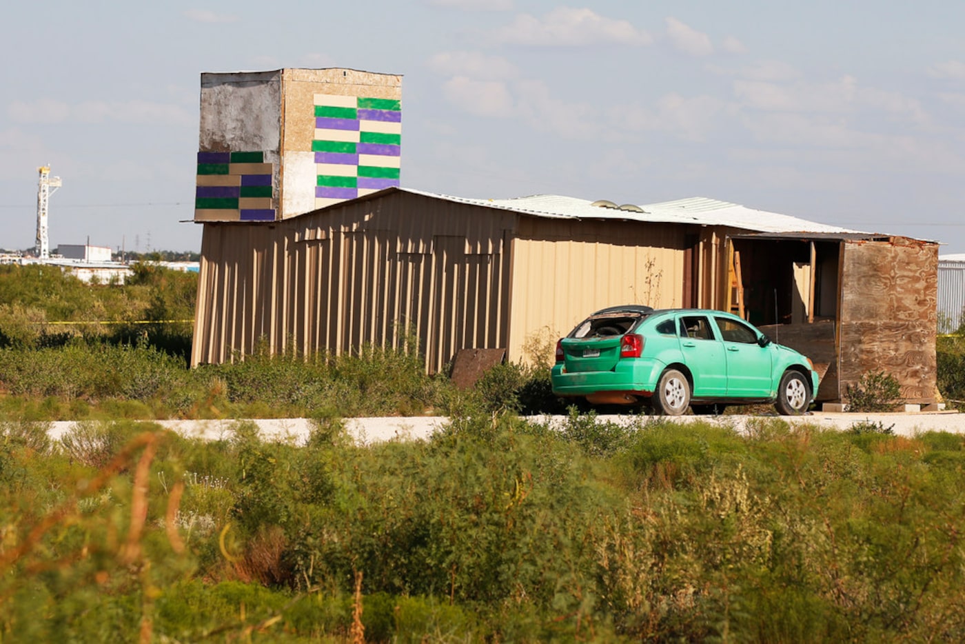 A drilling rig can be seen behind the home of Seth Ator, the alleged gunman in a West Texas...