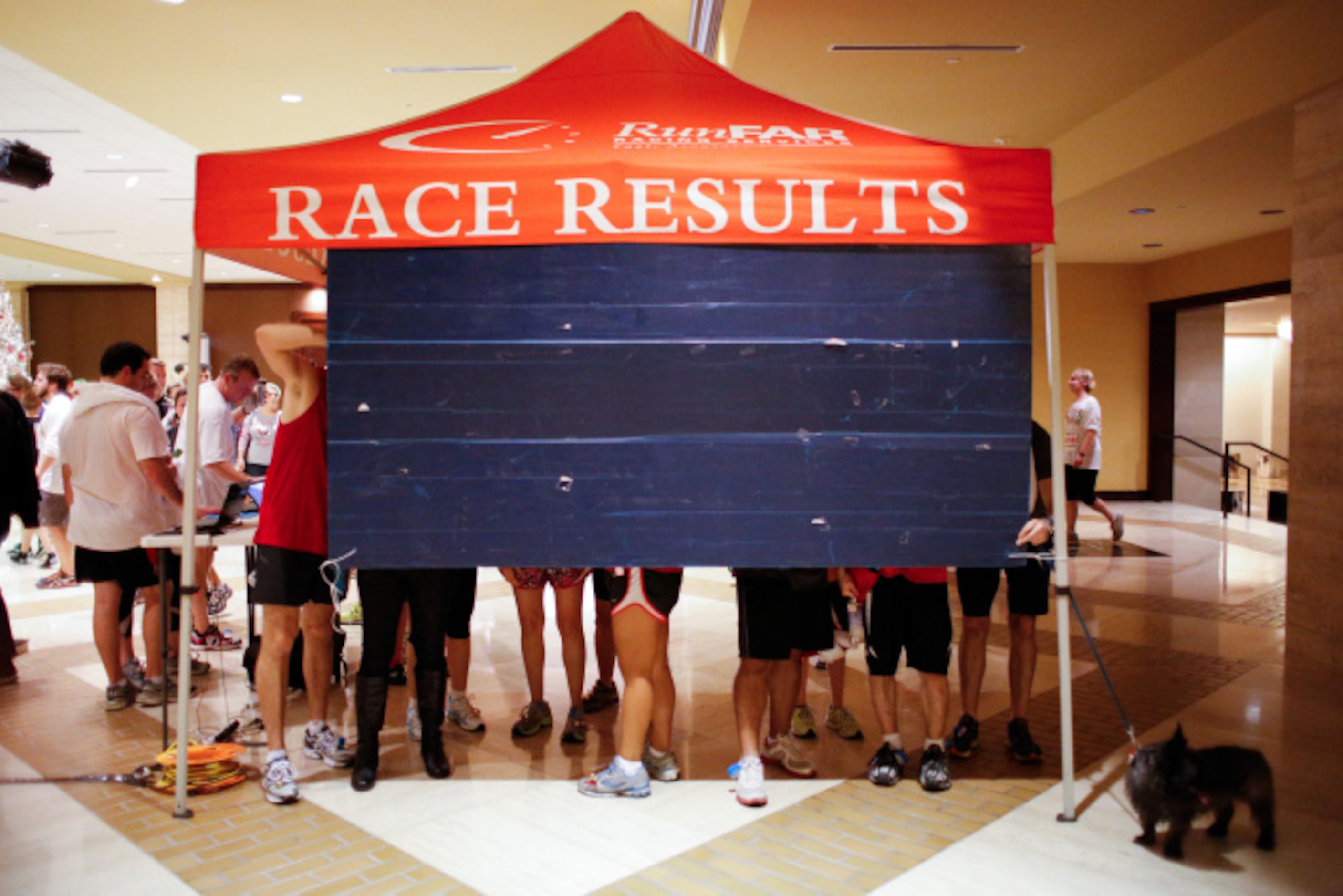 Thousands of runners check their Jingle Bell Run race times in the Hilton Anatole lobby in...