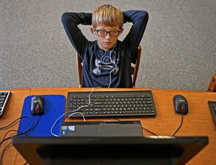 Fourth-grader Landon Gregory, 9, uses the Voice Dream Reader app on a desktop computer in...