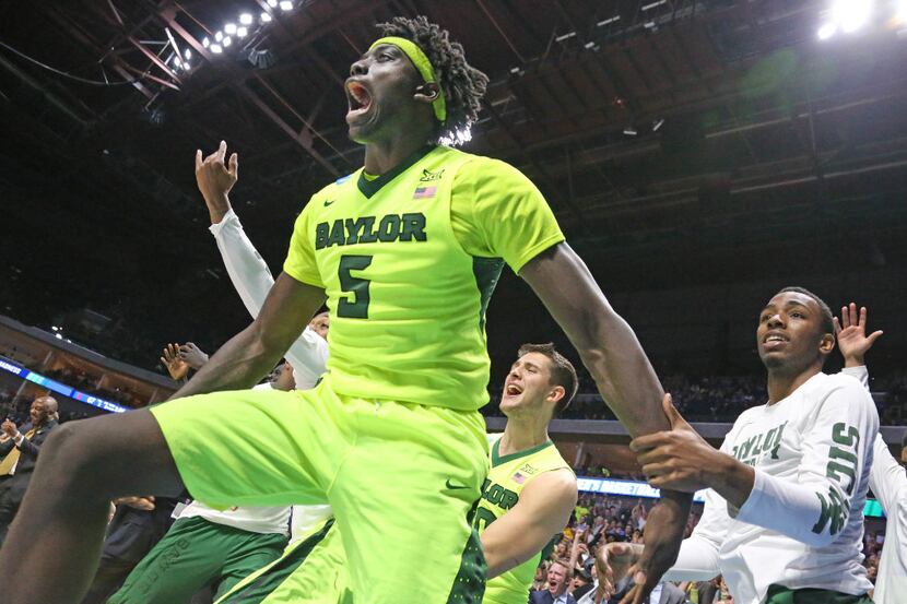 Baylor Bears forward Johnathan Motley (5) celebrates with teammates as time winds down in...