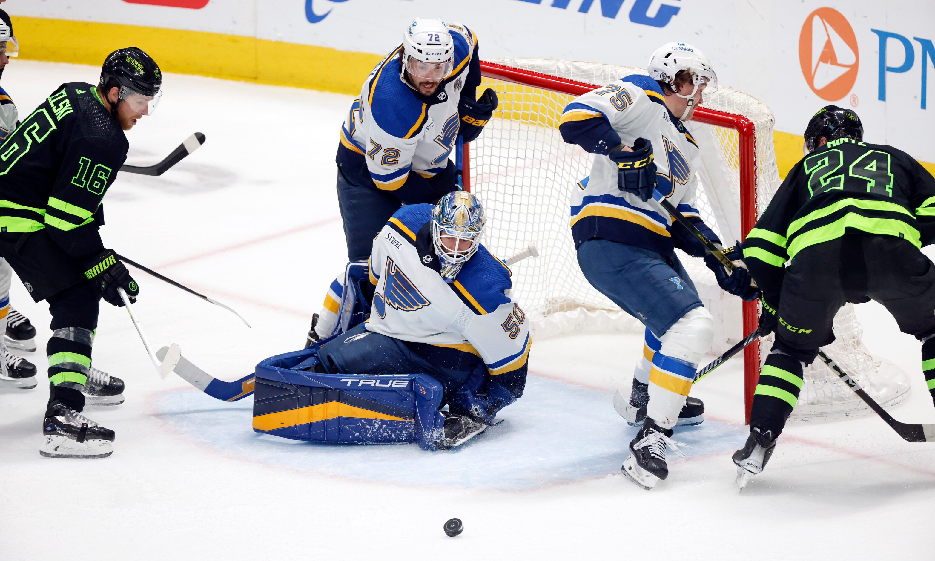 The puck shoots away from St. Louis Blues goaltender Jordan Binnington (50) during the...