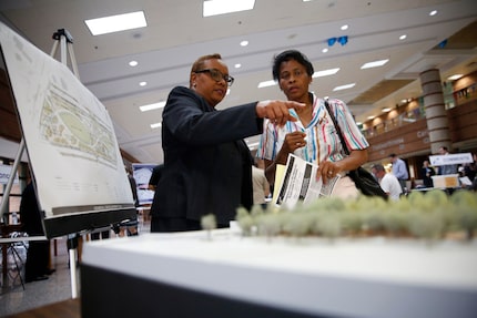 Sandra Williams (left), environmental specialist with TxDOT, speaks to Linda Smith, an Oak...