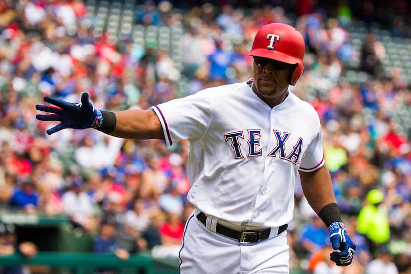 Texas Rangers third baseman Adrian Beltre celebrates after scoring on a groundout during the...
