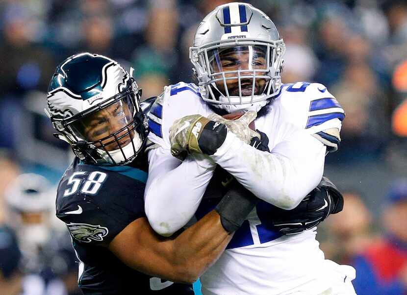 Dallas Cowboys running back Ezekiel Elliott (21) is tackled high by Philadelphia Eagles...