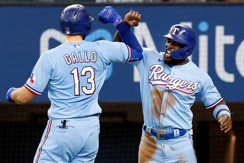 Texas Rangers batter Joey Gallo (13) is congratulated by Adolis Garcia after connected on a...