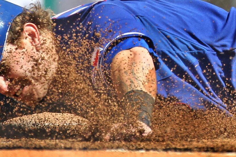 Texas' Josh Hamilton lands in the dirt as he is tagged out at home by Detroit C Victor...