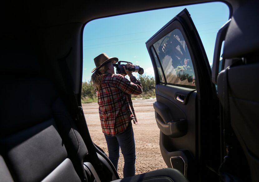 Sharon Wilson jumps out of her black rental SUV to check for emissions from a set of oil...