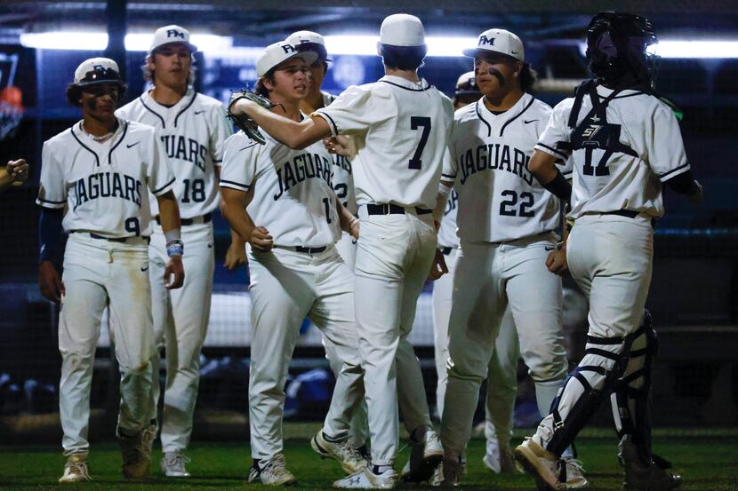 Flower Mound’s players celebrate their win against Coppell High after a baseball game at...