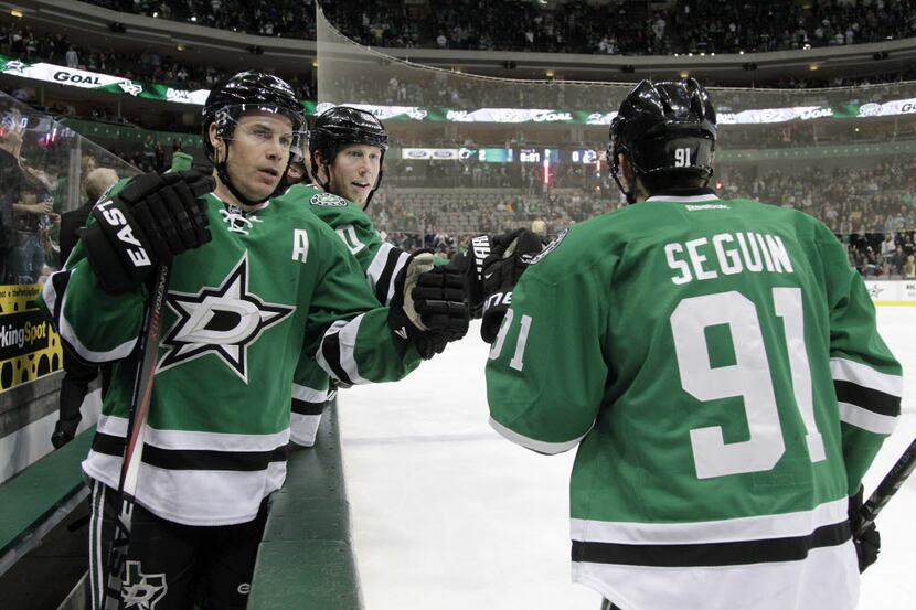 Dallas Stars left wing Ray Whitney (13) and center Cody Eakin (20) congratulate center Tyler...