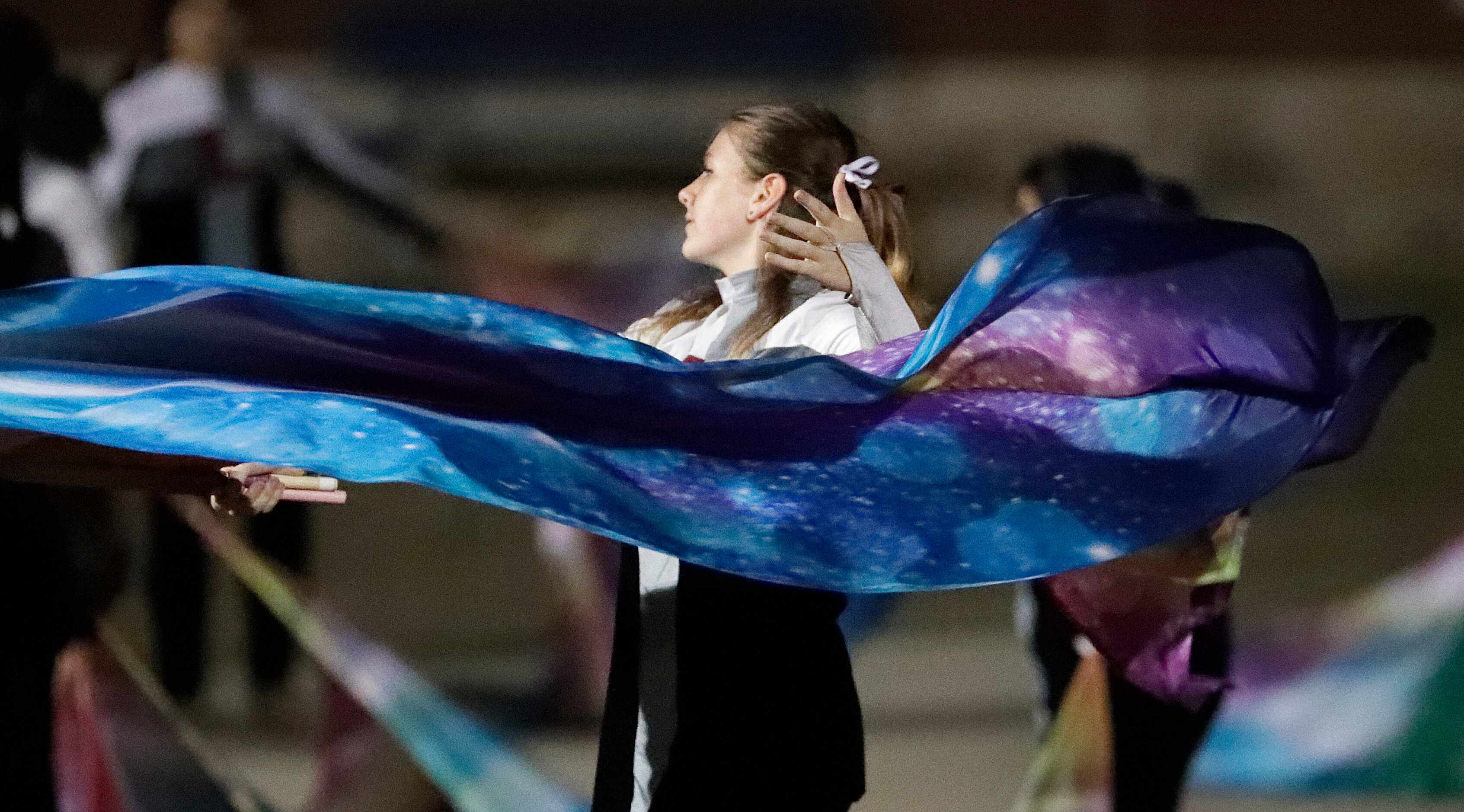 The Lewisville High School color guard practices their routine before half time as Hebron...