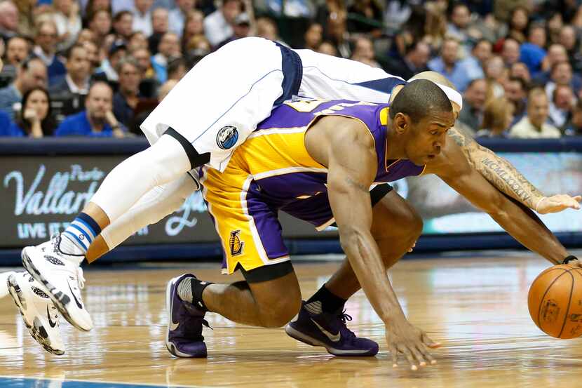 Los Angeles Lakers forward Metta World Peace (37) gets to the ball first as Dallas Mavericks...