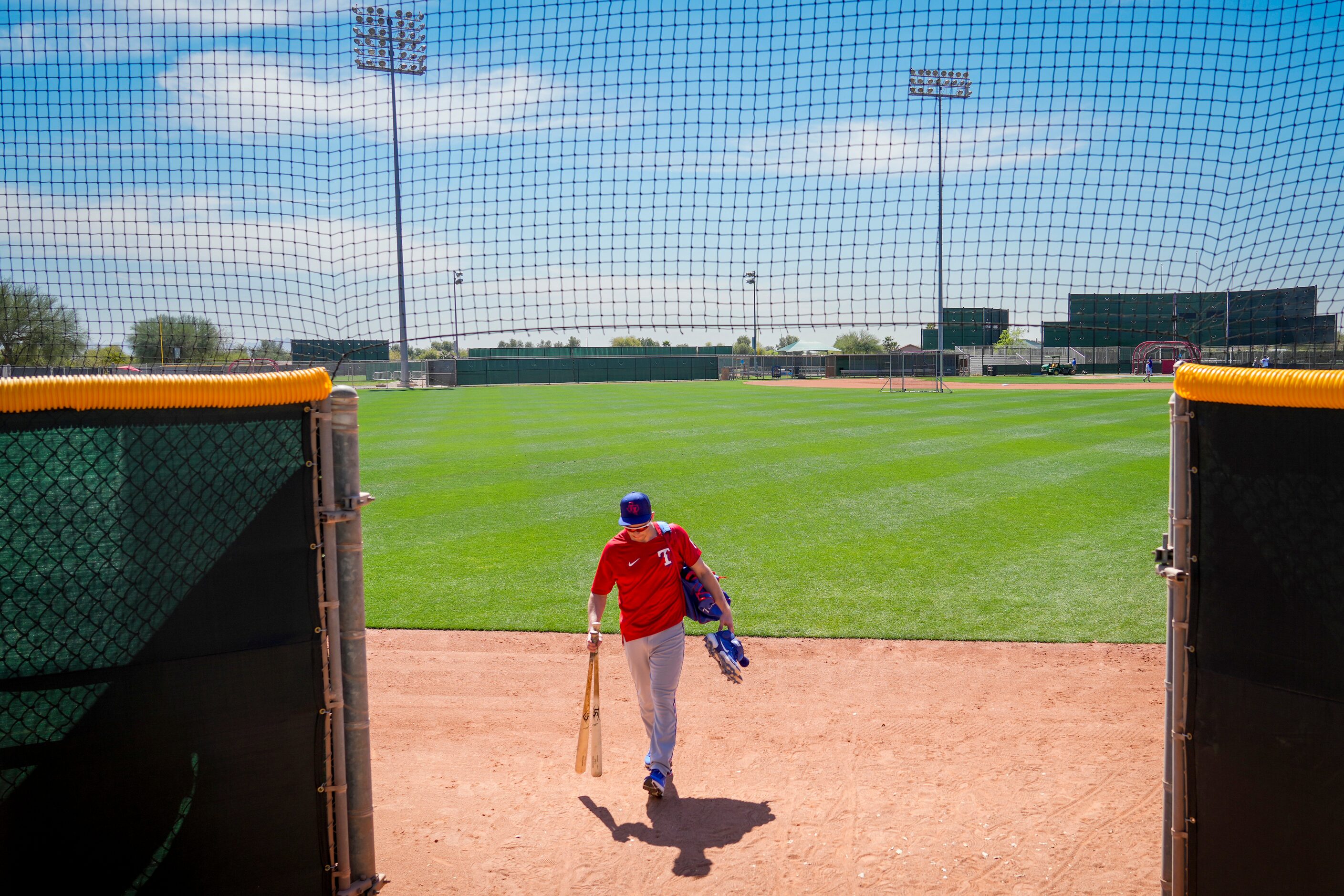 Texas Rangers infielder Nick Solak is the last major leaguer off the fields after staying...