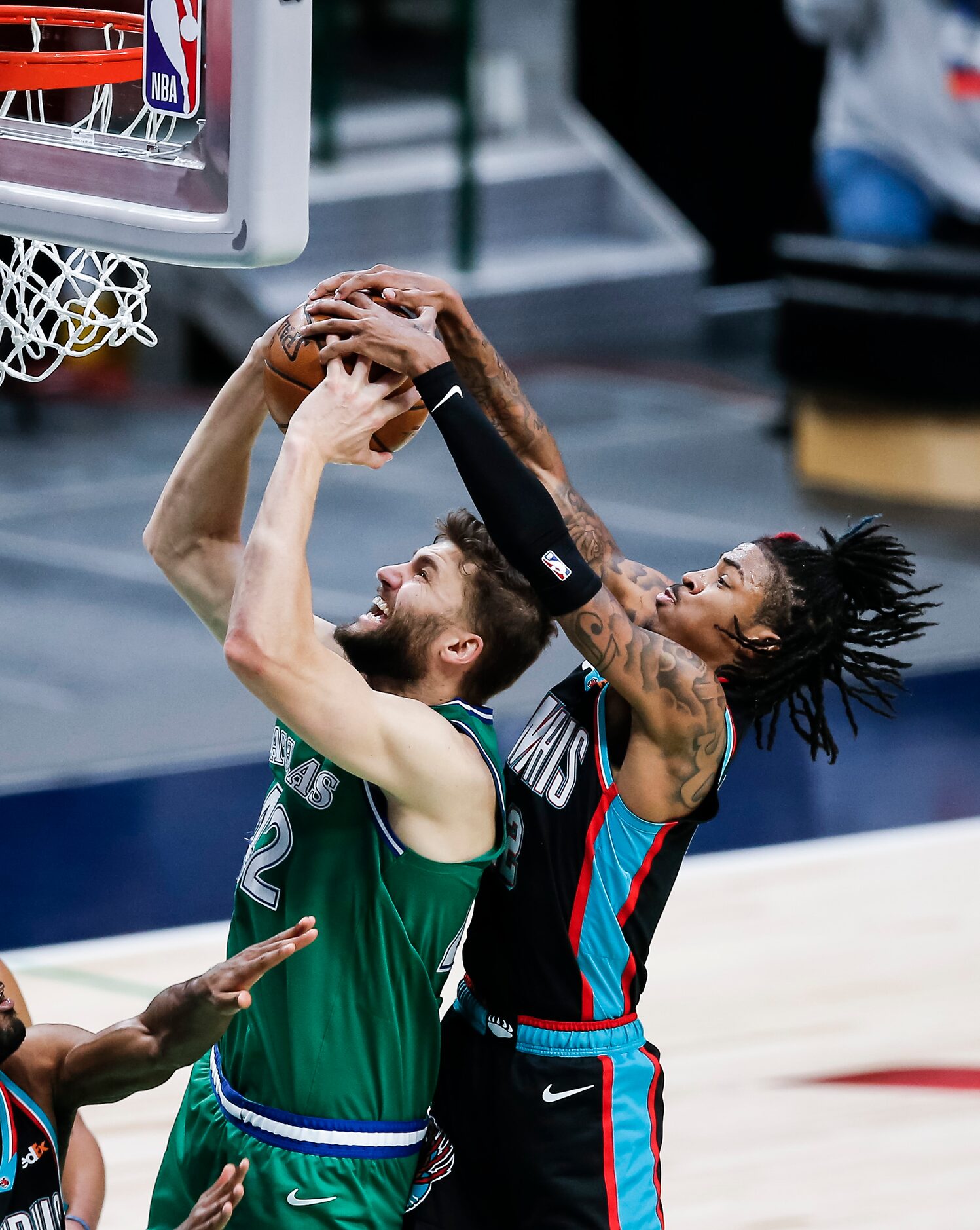 Memphis Grizzlies guard Ja Morant (12) fouls Dallas Mavericks forward Maxi Kleber (42)...