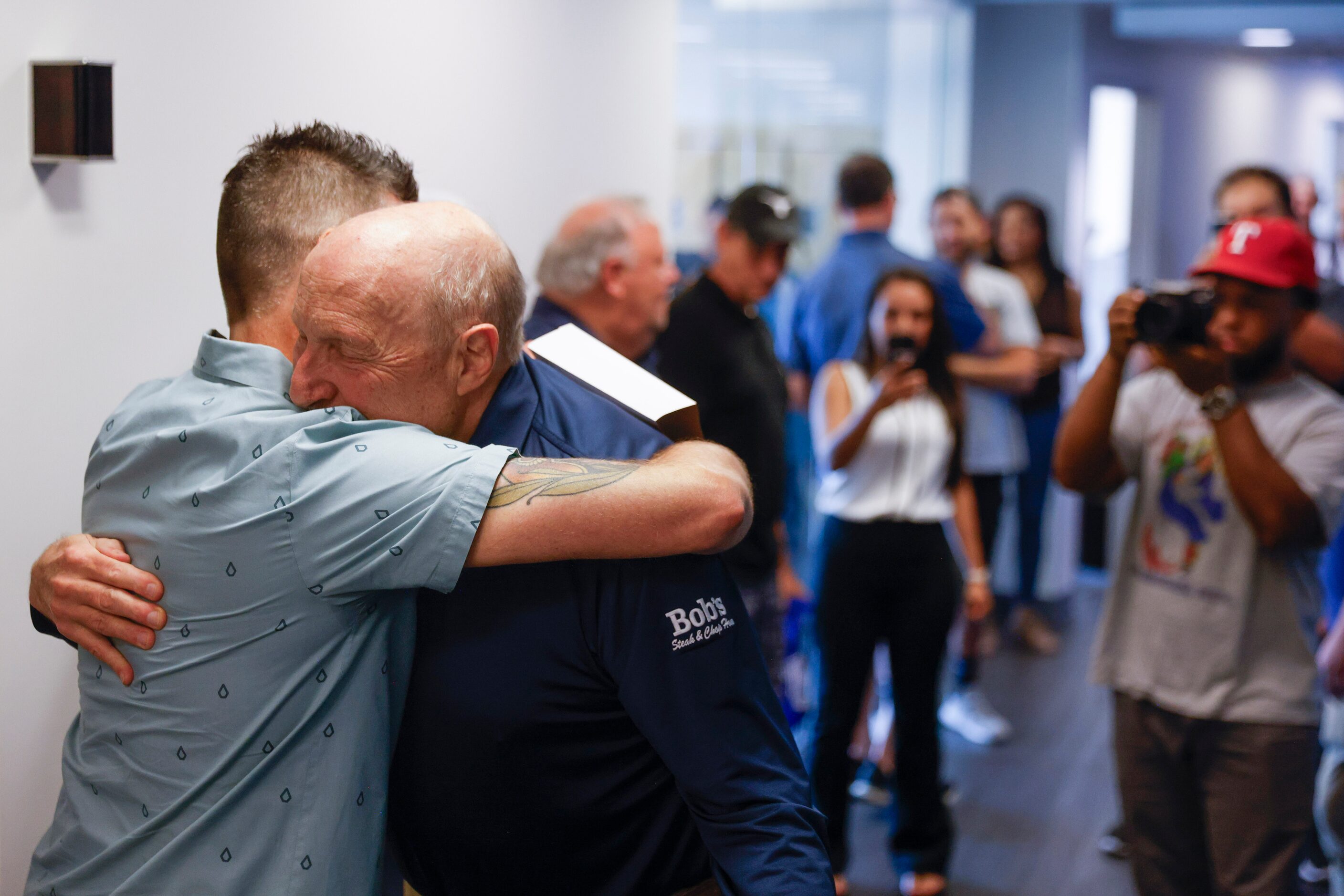 Jeff Catlin, (left), The Ticket program director, embraces local sports radio legend Norm...