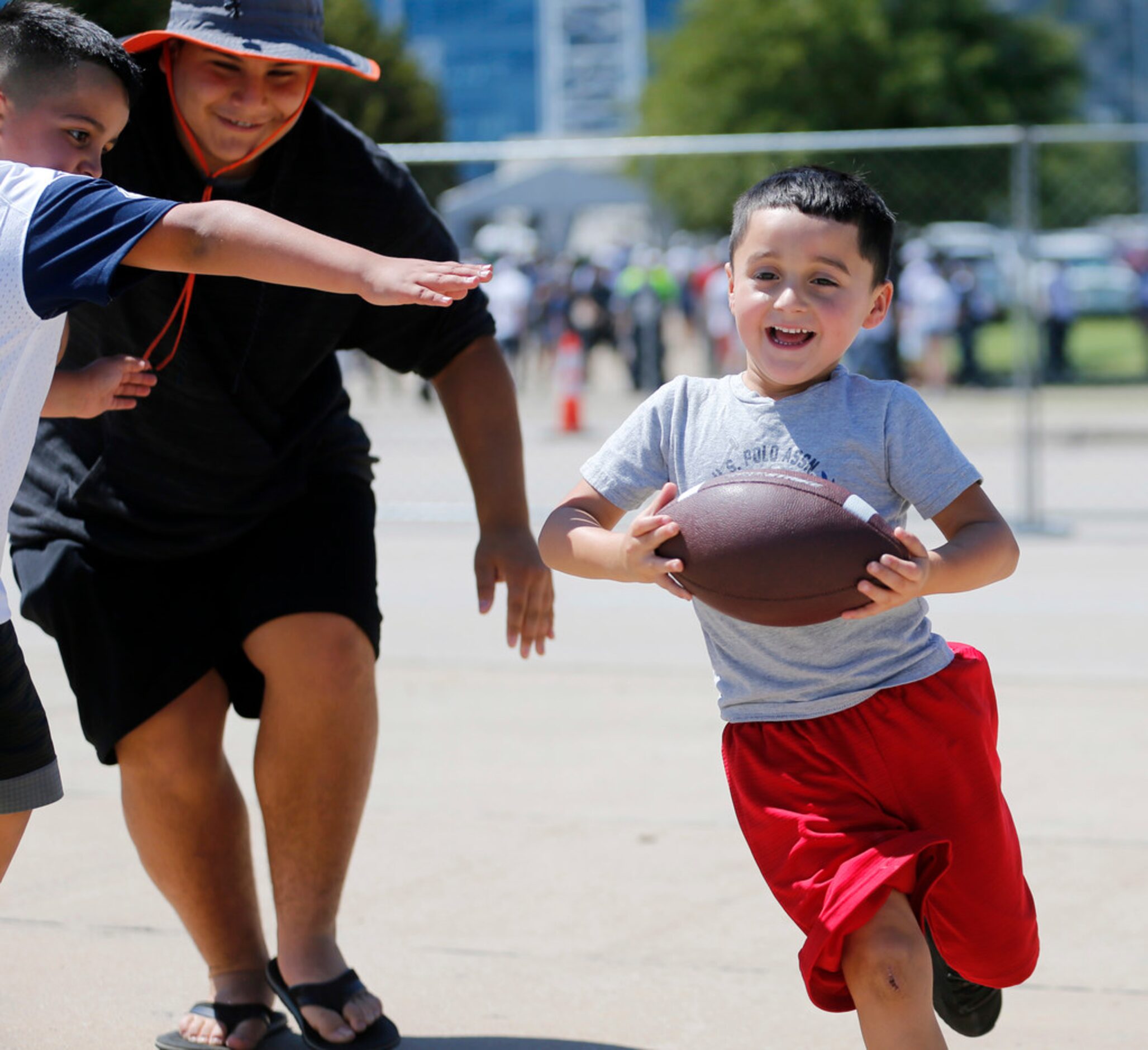 Samuel Garcia, 5 of Ferris, Texas runs in the parking lot as Ethan Garcia, 7 and Elias...