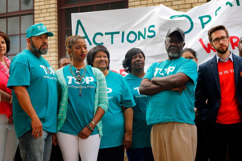 Members of TOP (Texas Organizing Project) listen to speakers at a news conference announcing...