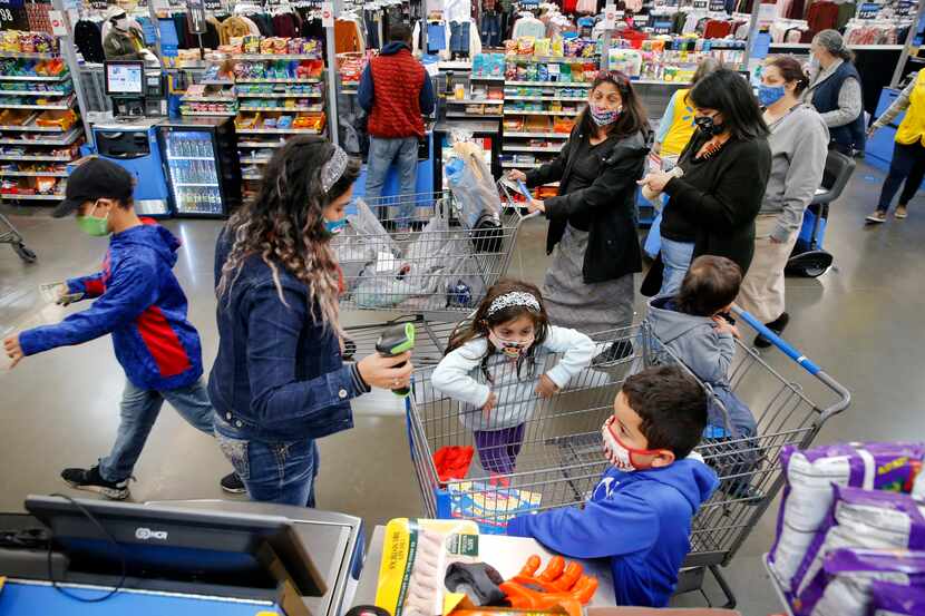 Shopper Evelin Huerta of Zapata, Texas and her children use a Scan & Go self checkout at the...