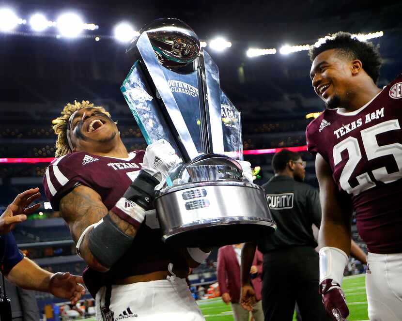 Texas A&M Aggies running back Trayveon Williams (5) hoists the winning Southwest Classic...