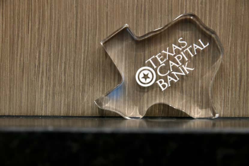 A paperweight of THE Texas Capital Bank branch on Singleton Boulevard. The bank named John...