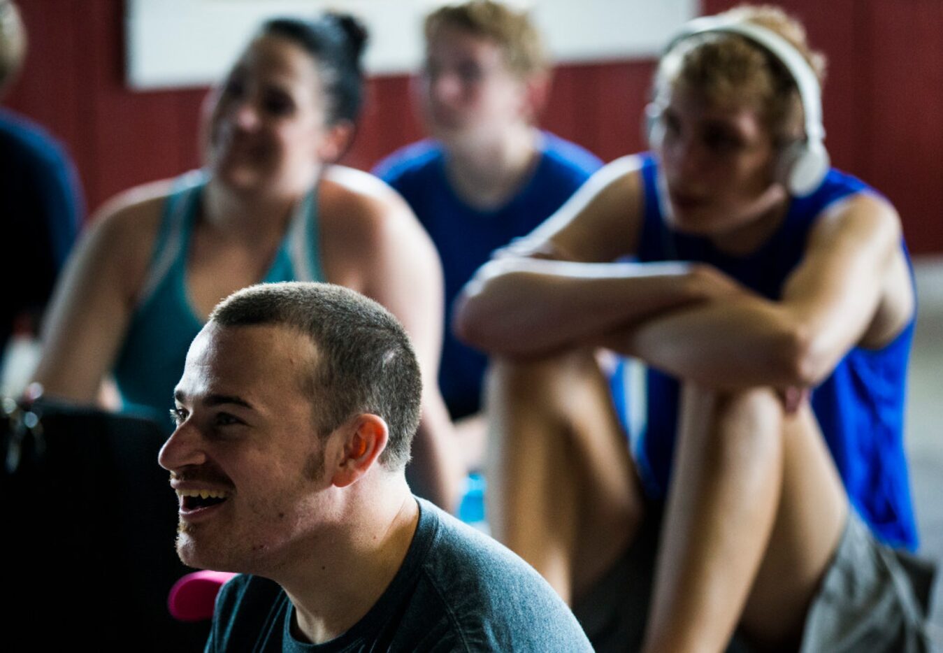 Davis Hecksel, 28, left, and other autistic adults and aides watch a program on animals at...