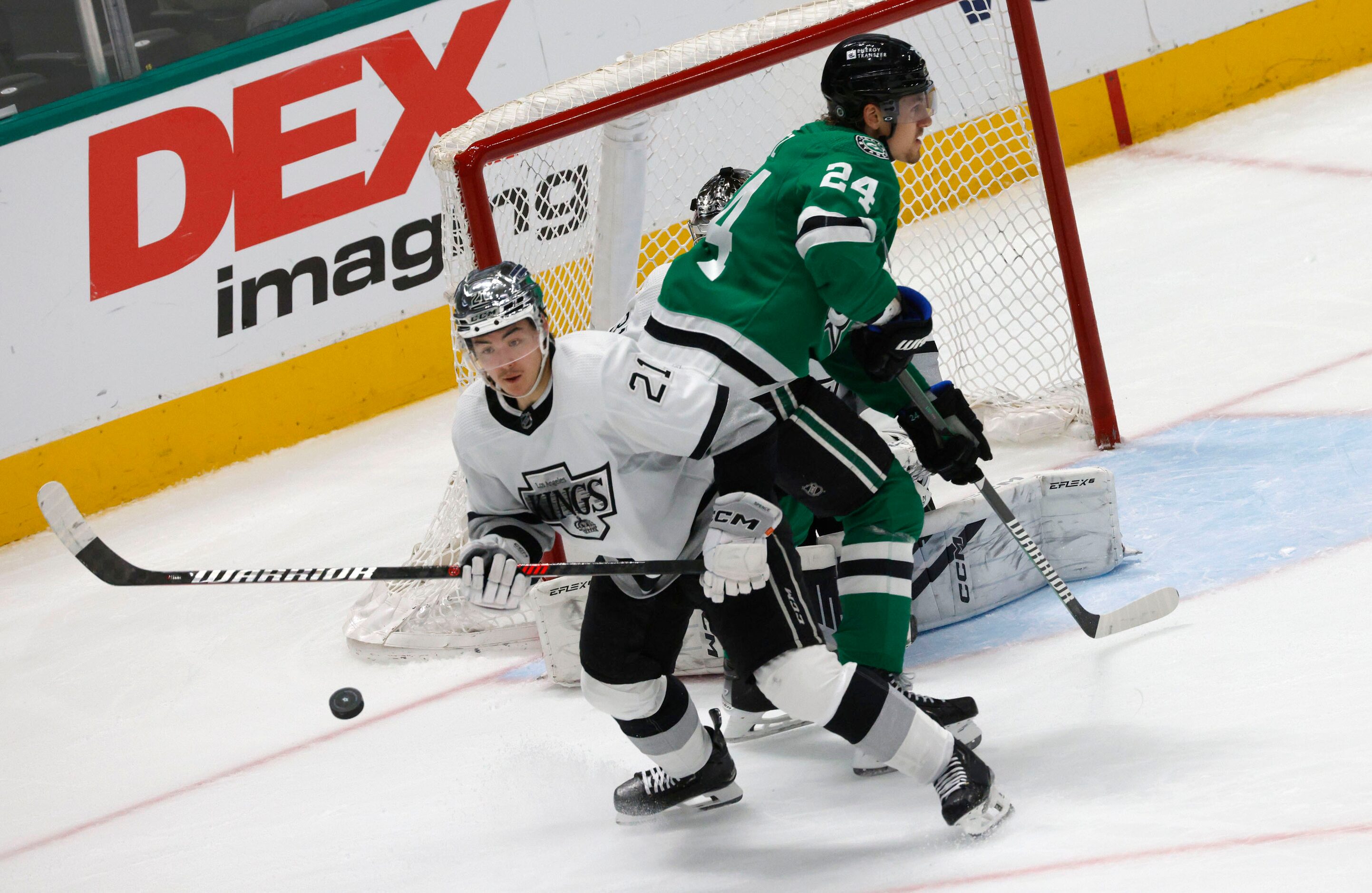 Los Angeles Kings defenseman Jordan Spence (21) tries to control the puck against Dallas...